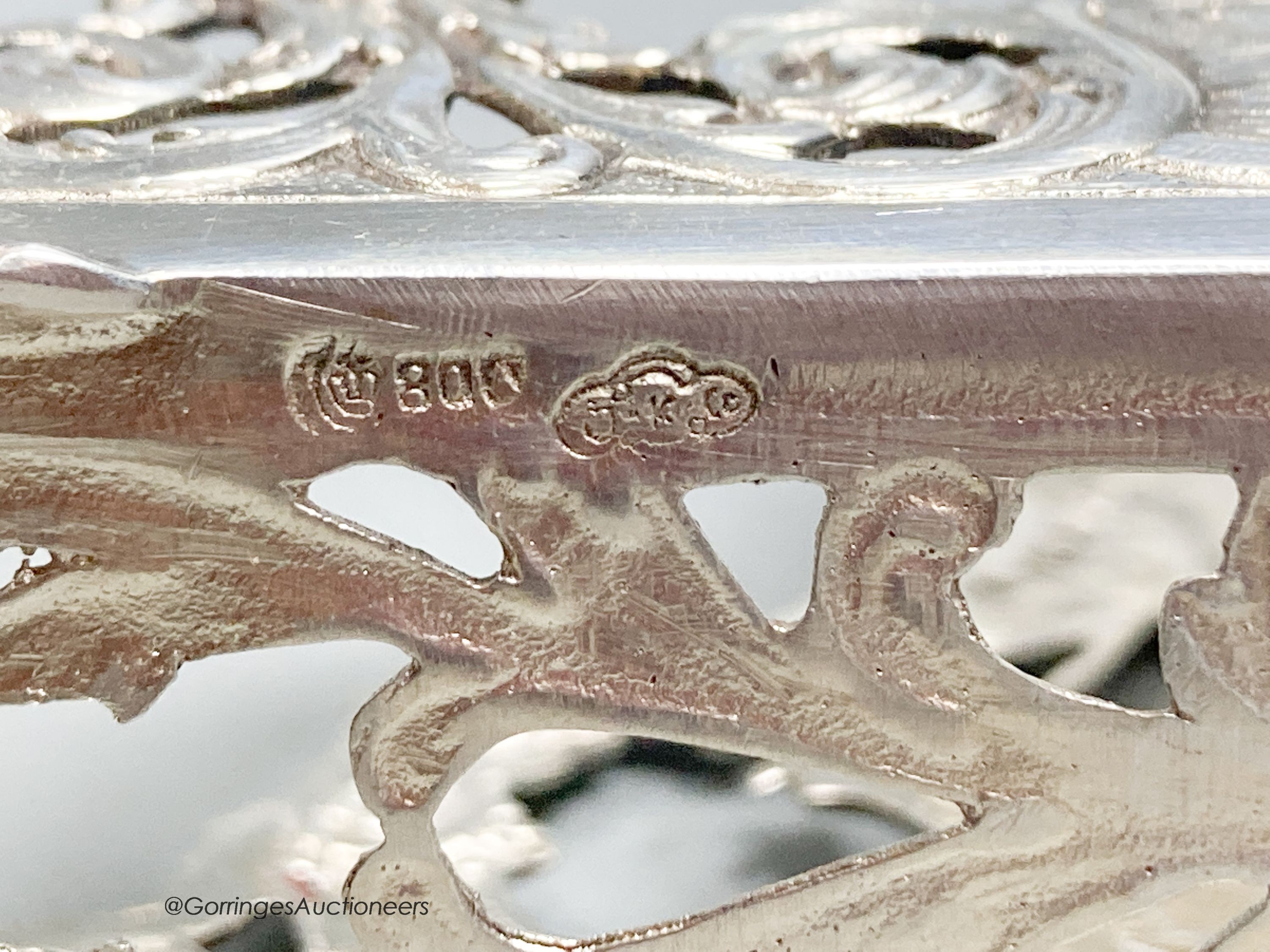 Two early 20th century German 800 standard pierced white metal letter racks, decorated with sailing ships, longest 13.8cm